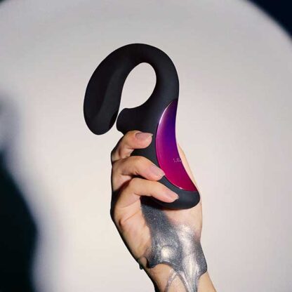Lelo Enigma Dual Stimulation Sonic Massager Being Held In Hand